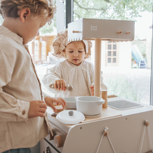 𝙉𝙚𝙬: Bistro kitchen! Each side of the bistro has different play options.⁣
The bistro set includes a chef's hat, cookware, an open sign and a chalkboard.⁣
Available in three colors 🤎💙💗⁣
⁣
⁣
⁣
⁣
#labellabel #kidsplayroom #playroomideas #playroominspo #playkitchen #learningthroughplay #woodenbistro #woodenkitchen